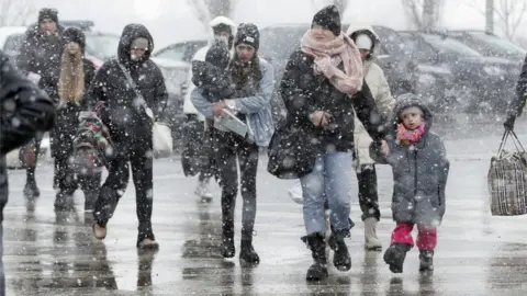 EPA Ukrainian people pass through the border crossing of Siret, northern Romania