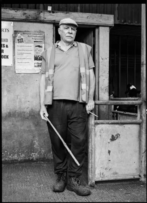 Damian Drohan A man holding a stick