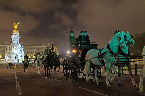 Getty Images A night time rehearsal for the coronation of King Charles III processes down The Mall on 18 April 2023 in London, England