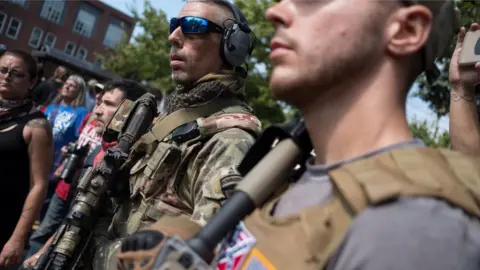 Reuters men carrying weaponry