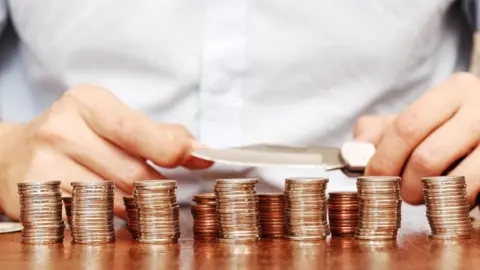 Getty Images loan shark with knife and money