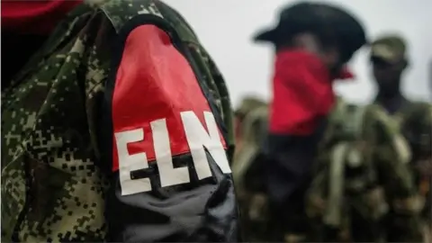 AFP This file photo taken on November 19, 2017 shows members of the "Omar Gomez" Western War Front of the National Liberation Army (ELN) rebel group lining up in their camp on the banks of the San Juan River, Choco department, Colombia