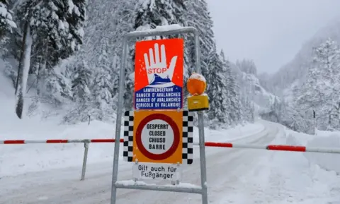 Reuters A sign warning of avalanche danger is seen on a closed road after heavy snowfall near Obertauern, Austria