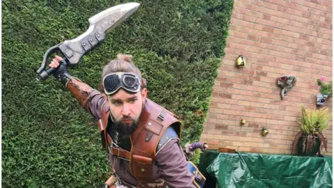 Matthew Barry Matthew is pictured in some of his cosplay outfit in his garden