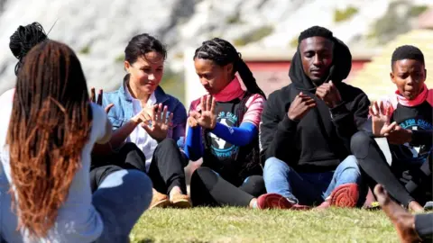 Reuters Meghan with members of Waves for Change