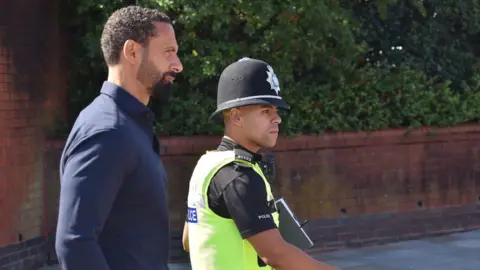 PA Media Ex-England footballer Rio Ferdinand (left) leaving Wolverhampton Crown Court after a hearing at which Jamie Arnold denied a racially aggravated public order offence.