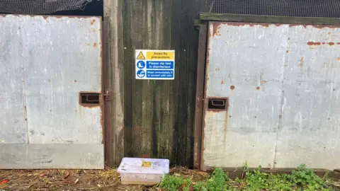 A warning sign on an entrance to the paddock