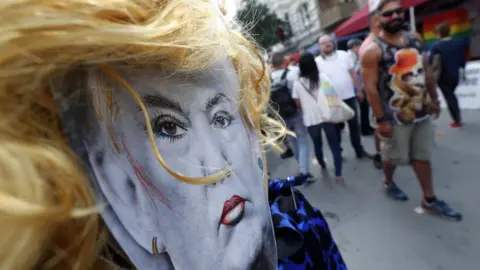 EPA Cardboard face of US President Donald Trump with make up