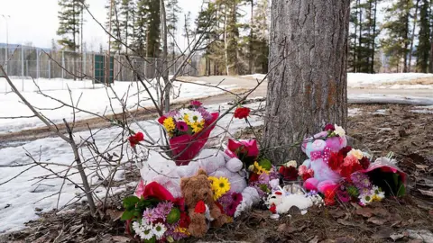 AFP via Getty Images Flowers left near the scene of Tumbler Ridge shooting. 