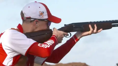 Henry Lungley holding a rifle