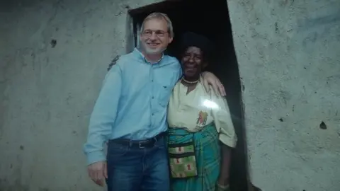 Jean Pierre Bucyensenge Zura Karuhimbi with a European man