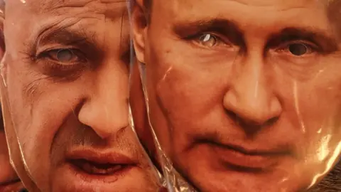 EPA Face masks depicting Wagner chief Yevgeny Prigozhin and Russian President Vladimir Putin displayed for sale at a souvenir market in St. Petersburg, 28 June 2023