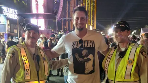 David Bugenske David Bugenske (centre) with two police officers at Harvest 91 before the shooting
