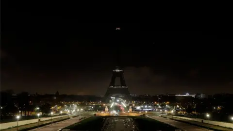 Getty Images The Eiffel Tower goes dark in memory of the victims of the attack on Christmas shoppers at a market in Strasbourg, France, 13 December 2018