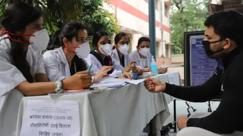 SOPA Images A man speaks to healthcare workers in India