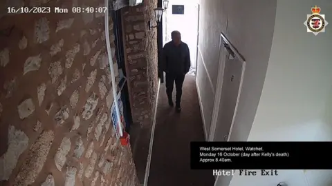 Man walking down corridor on CCTV image