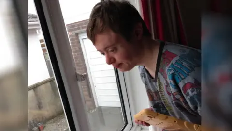 Family handout Ben looking out window