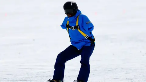 Dean Onwuchekwa snowboarding