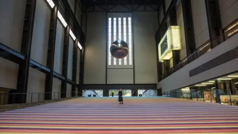 Getty Images Woman on carpet looking at pendulum