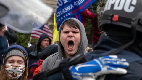 Getty Images Pro-Trump protestors clash with police during the tally of electoral votes that that would certify Joe Biden as the winner of the US election