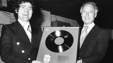 Max Boyce receives a silver disc for his album 'Live at Treorchy' from record industry bosses