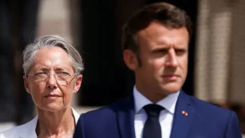 French President Emmanuel Macron and French Prime Minister Elisabeth Borne attend a ceremony