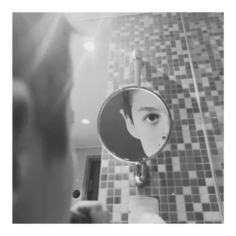 Richard Tymon Riley in a mirror