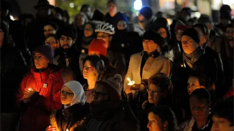 AFP Community members hold candles at a vigil for the victims of the Pittsburgh Synagogue shooting at Cambridge City Hall in Cambridge, Massachusetts