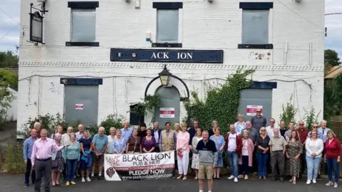 Jane Mosley Villagers outside the Black Lion pub, in Skelton-on-Ure