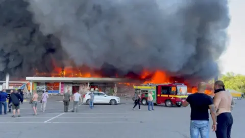 TELEGRAM/V_ZELENSKIY_OFFICIAL Flames engulfing the mall in Kremenchuk