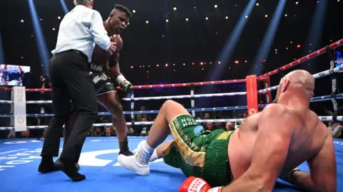 Getty Images Tyson Fury hits the canvas in his fight against Francis Ngannou