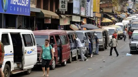 AFP Private microbuses wait for Brazilians from Foz do Iguacu, while they do their shopping in Ciudad del Este, Paraguay, 11 September 2010.