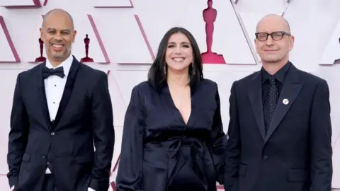 Reuters Jesse Collins, Stacey Sher and Steven Soderbergh at the 2021 Oscars