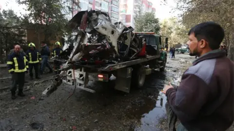 EPA Authorities remove wreckage from the scene of an attack in Kabul