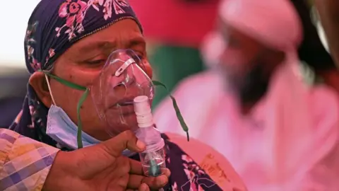 Getty Images Patients breathe with the help of oxygen provided by a Gurdwara, a place of worship for Sikhs, under a tent installed along the roadside amid Covid-19 coronavirus pandemic in Ghaziabad on April 26, 2021.