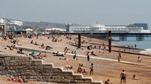 Reuters People are seen on Brighton beach following the outbreak of the coronavirus disease (COVID-19), Brighton, Britain