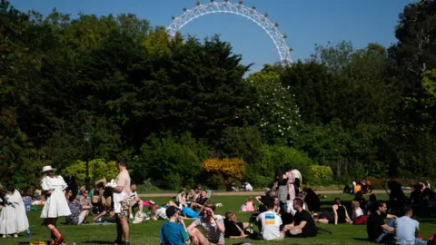 Pool Members of the public enjoy the sun in St James Park on Sunday