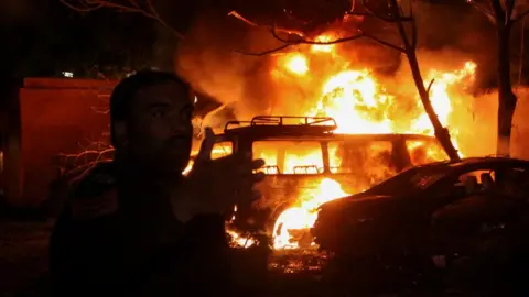 Reuters A police officer reacts after an explosion at a luxury hotel in Quetta, Pakistan