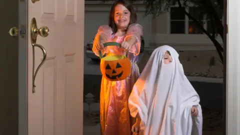 Getty Images Children trick or treating on Halloween.