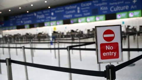 Reuters An empty British Airways check in desk area at an empty Gatwick airport