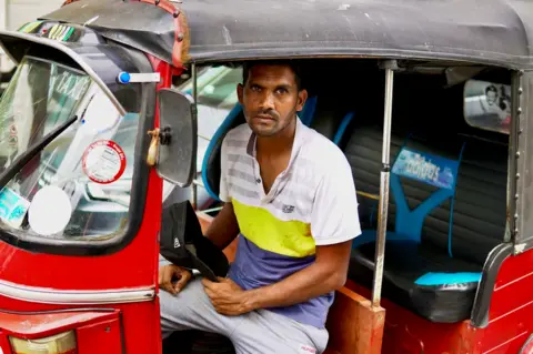 BBC/Tessa Wong Gayan Kalanda, tuk-tuk driver, queuing for fuel on 11 July 2022