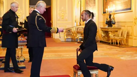 PA Media Sir Lewis Hamilton is made a Knight Bachelor by the Prince of Wales at Windsor Castle