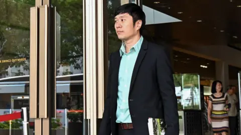 Getty Images Jolovan Wham leaving High Court in 2019 for an earlier case