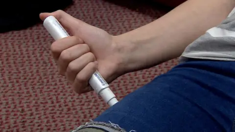 BBC Girl using an allergy pen