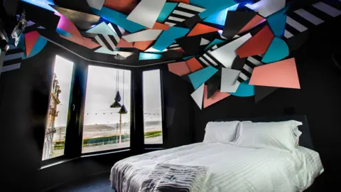 CJ Griffiths A light installation on the ceiling of artist Mark McClure's room brings the Blackpool illuminations indoors