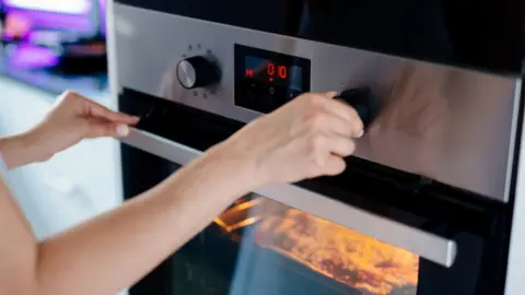 Getty Images Person using electric cooker