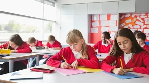 Getty Images Children in class writing