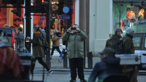 Counter Terrorism Policing South East Surveillance image of Lewis Ludlow taking pictures in Oxford Street