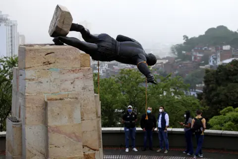 AFP The statue of Sebastian de Belalcazar, a 16th century Spanish conqueror, lies after it was pulled down by indigenous people in Cali, Colombia, on April 28, 2021. -