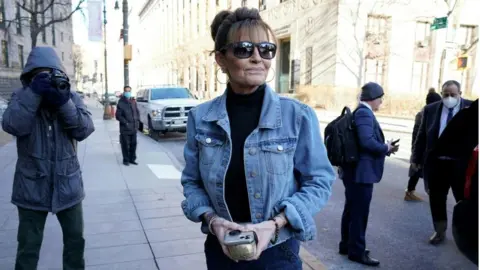 Getty Images Ms Palin seen arriving at court on Tuesday in a denim jacket